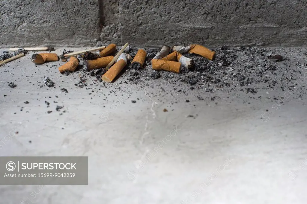 Discarded cigarette butts on ground