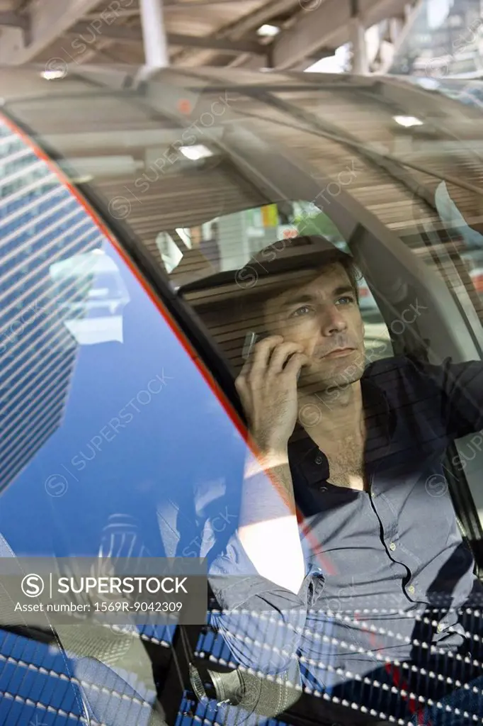 Man using cell phone while driving