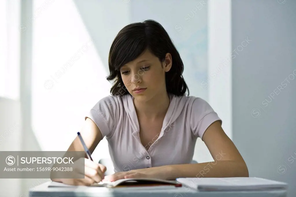 Teenage girl focusing on classwork assignment