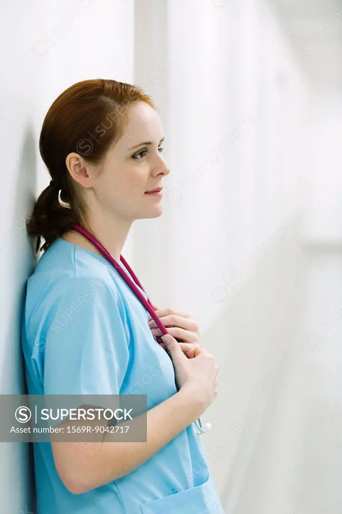 Nurse leaning against wall, portrait