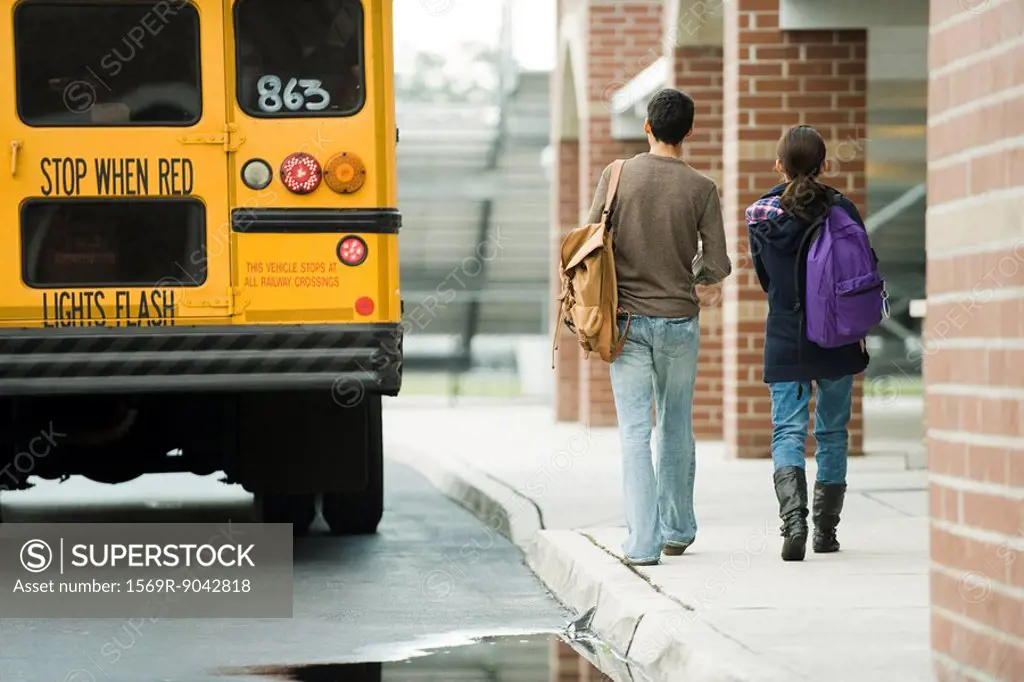 High school students walking toward school bus