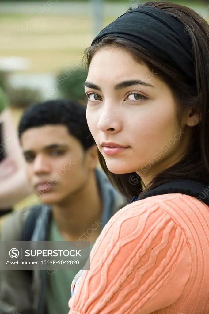 Teenage girl looking over shoulder, portrait