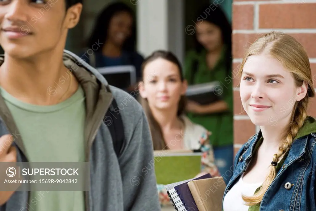 Young woman admiring student walking past