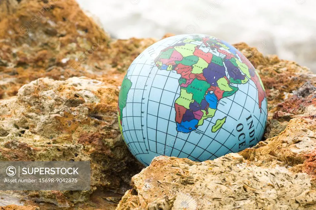 Globe nestled in rock
