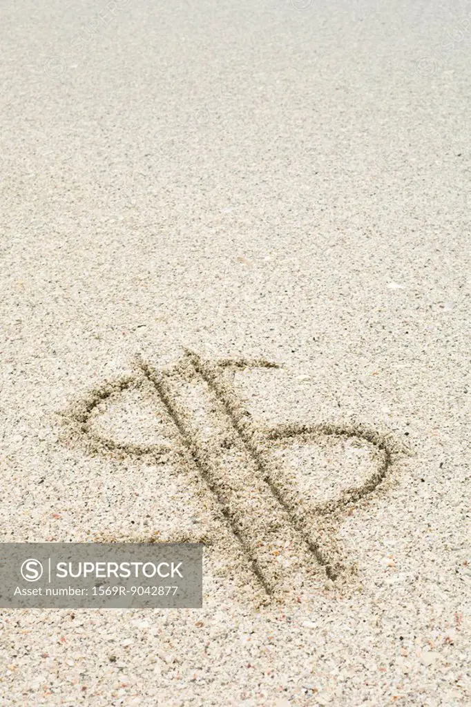 Dollar sign drawn in sand at the beach