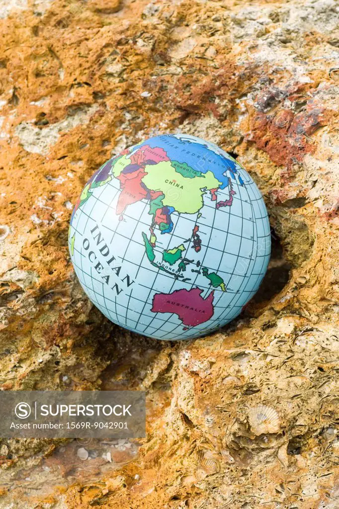Globe nestled in rock