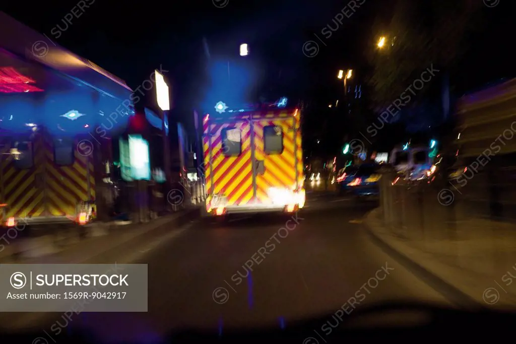 Ambulance driving on street at night