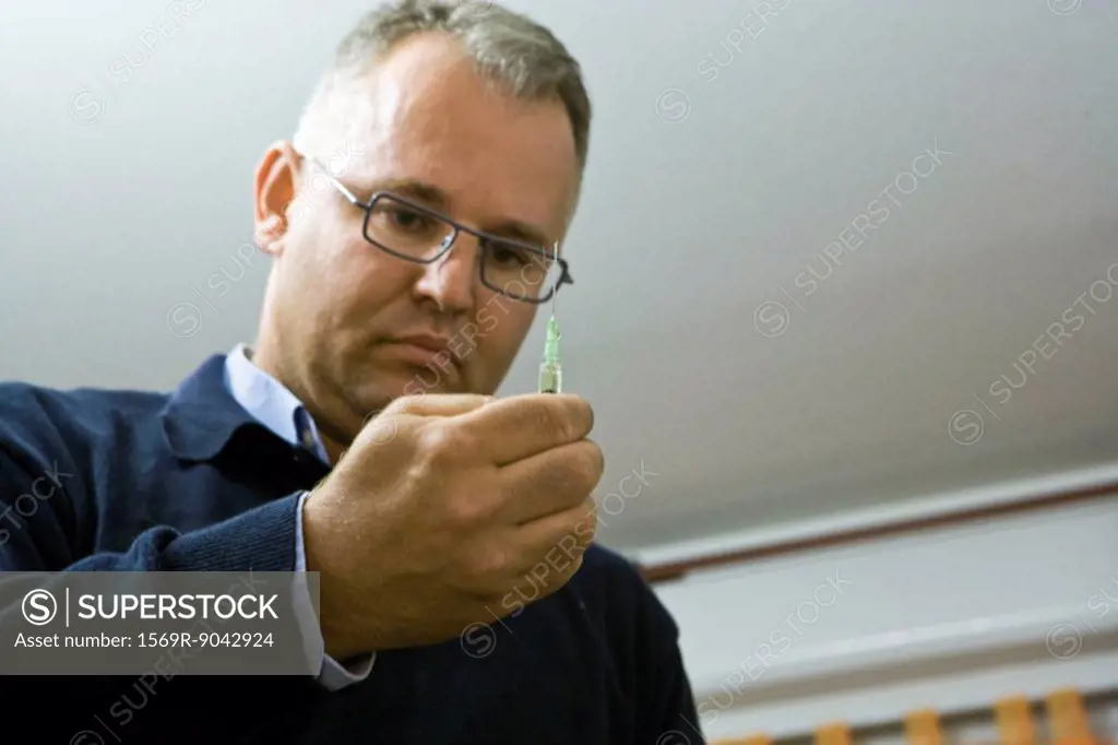 Doctor preparing injection
