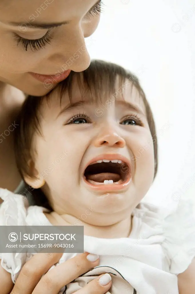 Mother holding crying infant