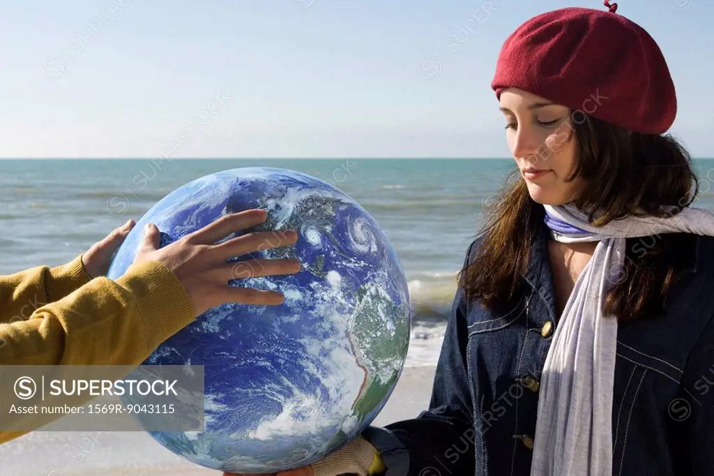 Teenage girl holding earth