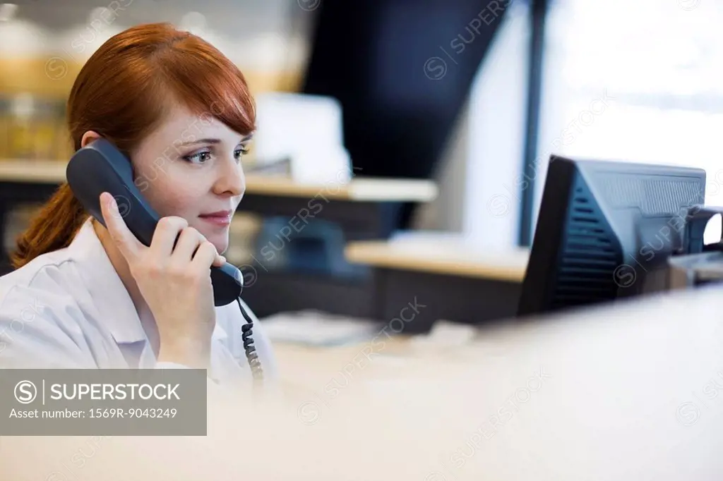 Female receptionist talking on phone