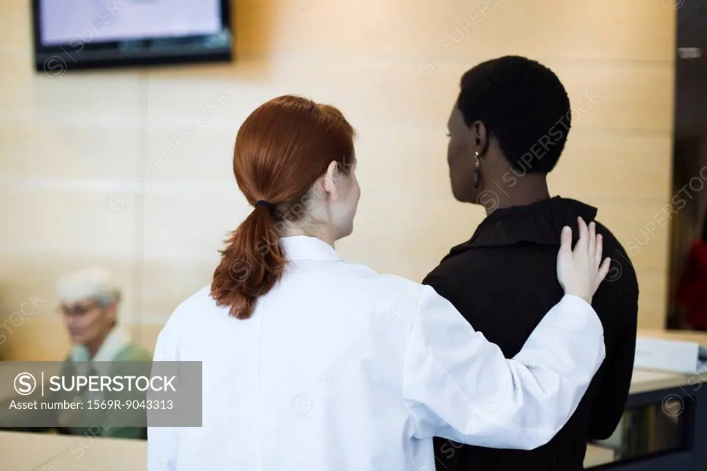Female healthcare worker reassuring patient