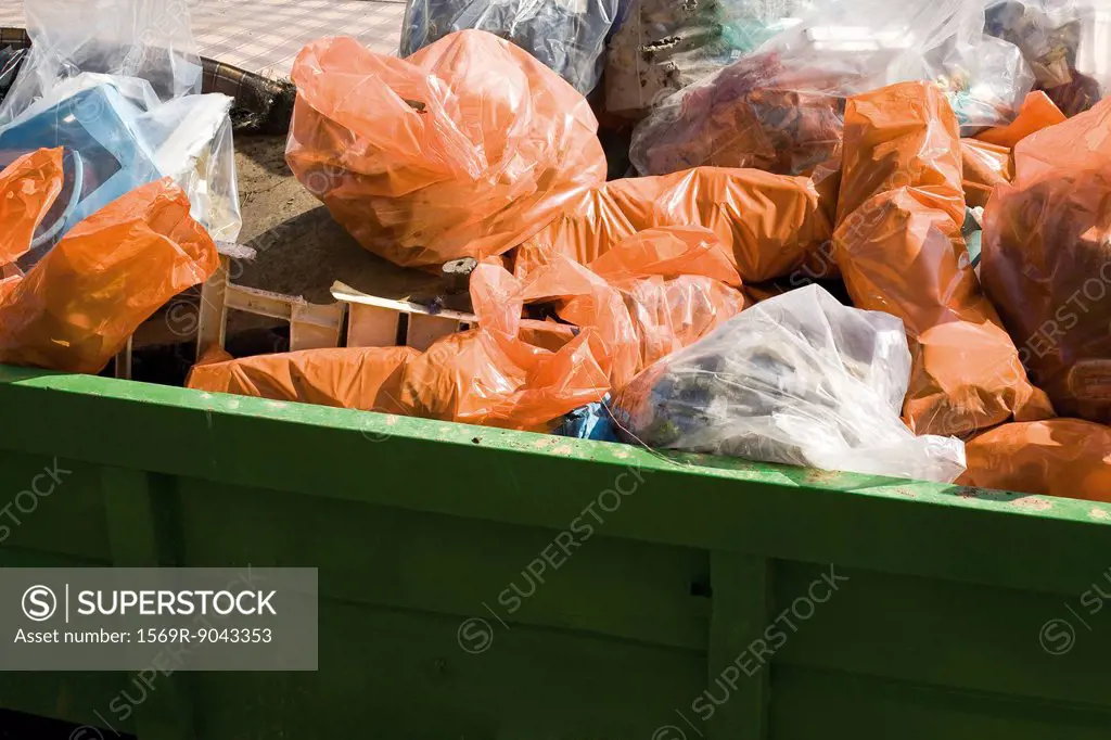 Dumpster full of garbage bags