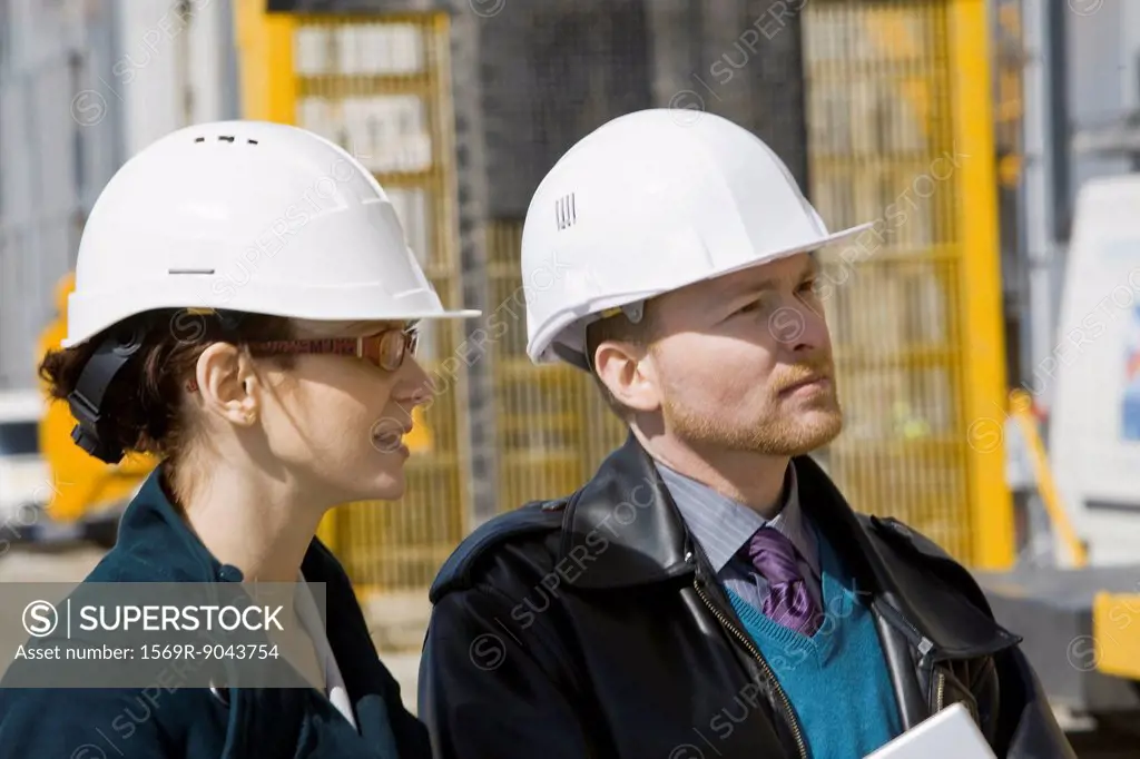 Business people in hard hats