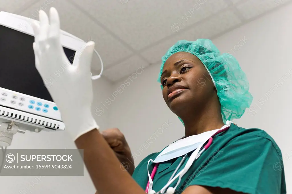 Nurse putting on latex gloves