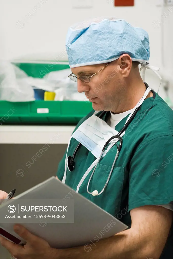 Surgeon reviewing patient´s medical chart