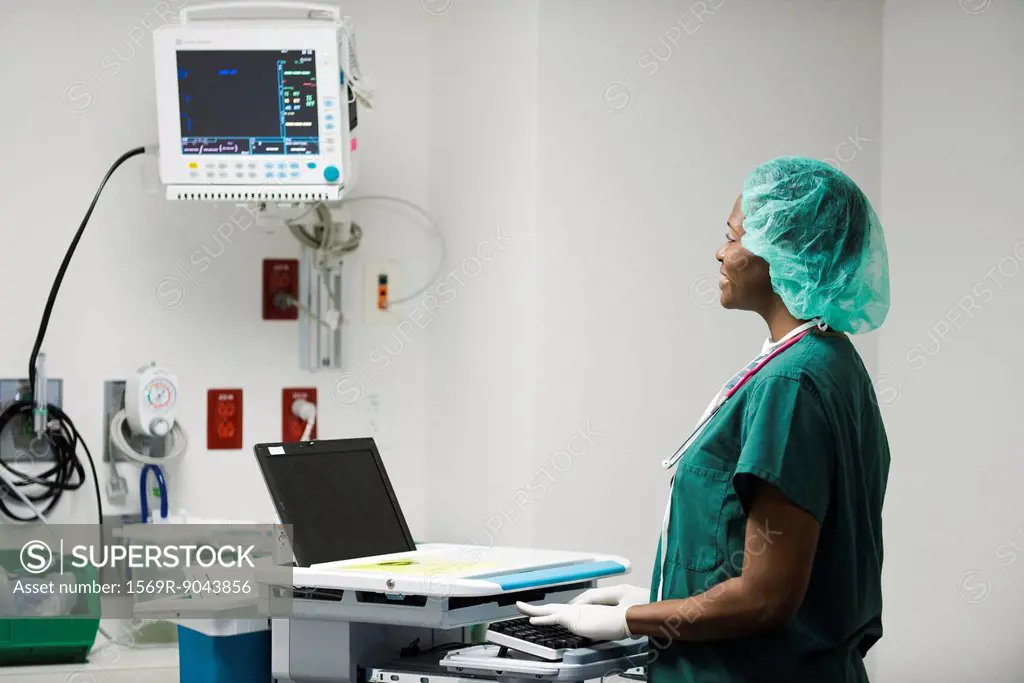 Nurse using computerized medical equipment