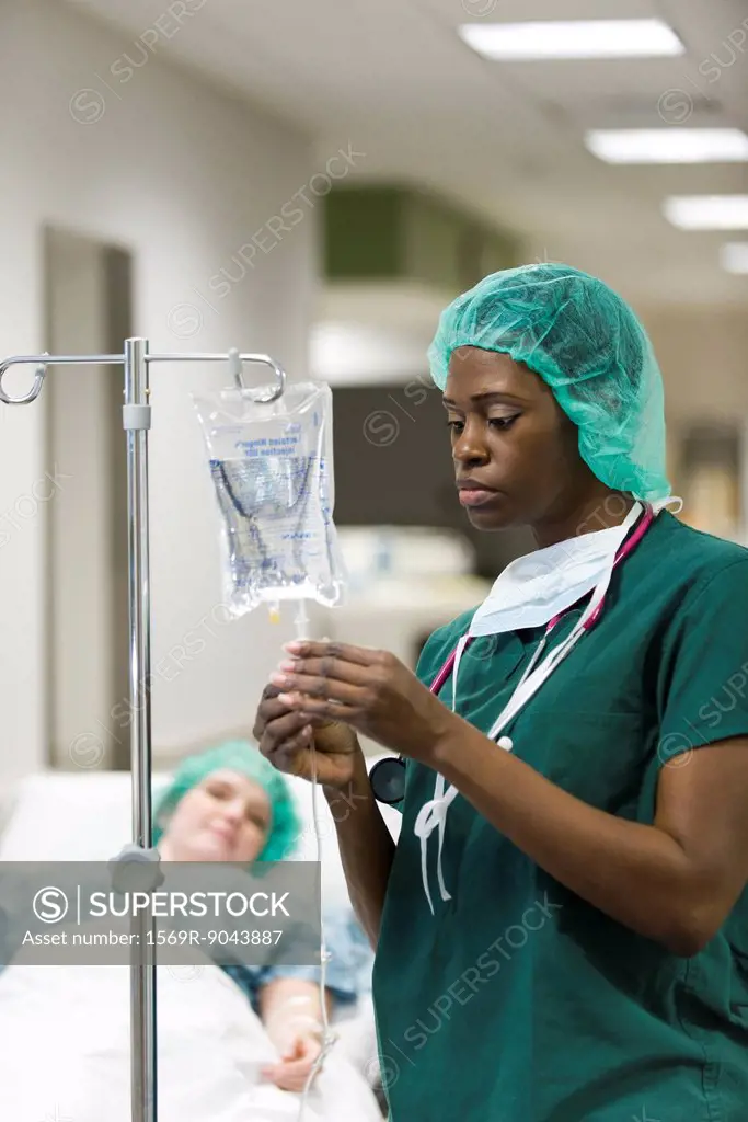 Nurse checking patient´s IV drip