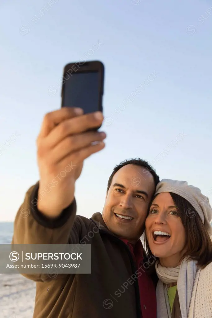 Mature couple photographing themselves with photophone