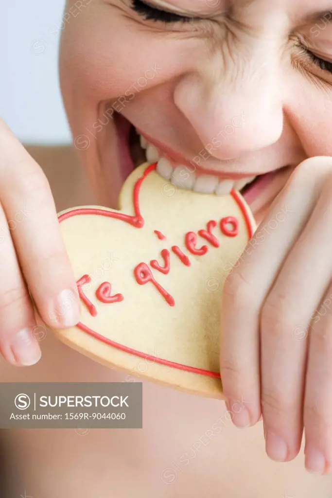 Biting into heart_shaped cookie