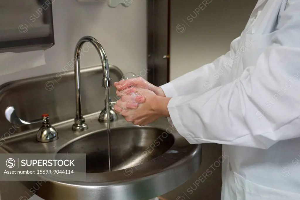 Healthcare professional washing hands, cropped