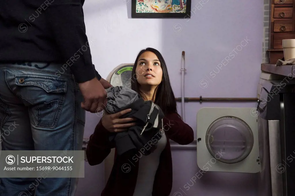 Couple doing laundry together, cropped