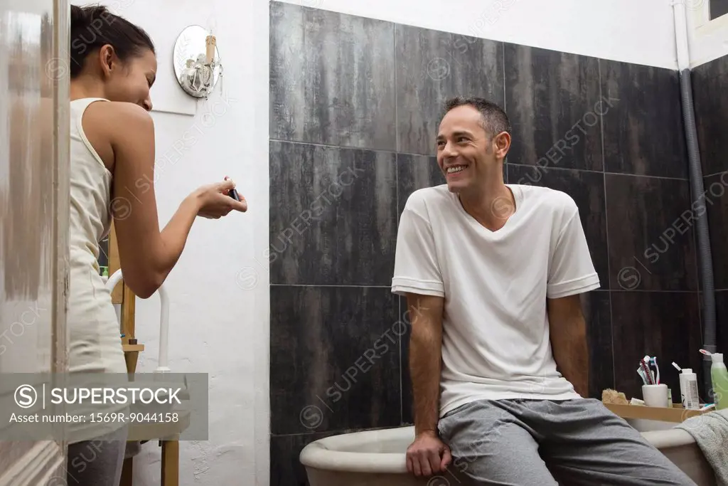 Couple talking and laughing in bathroom