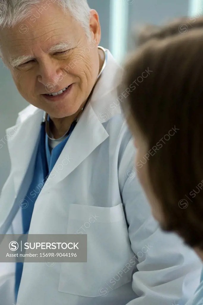 Doctor talking and smiling with patient