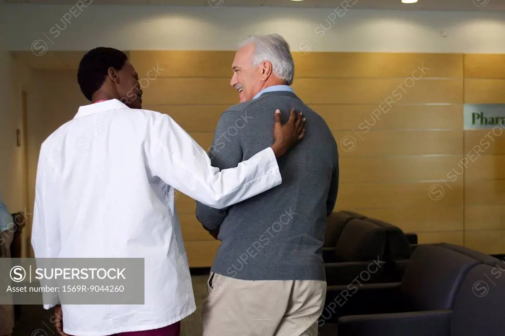 Doctor walking and talking with patient