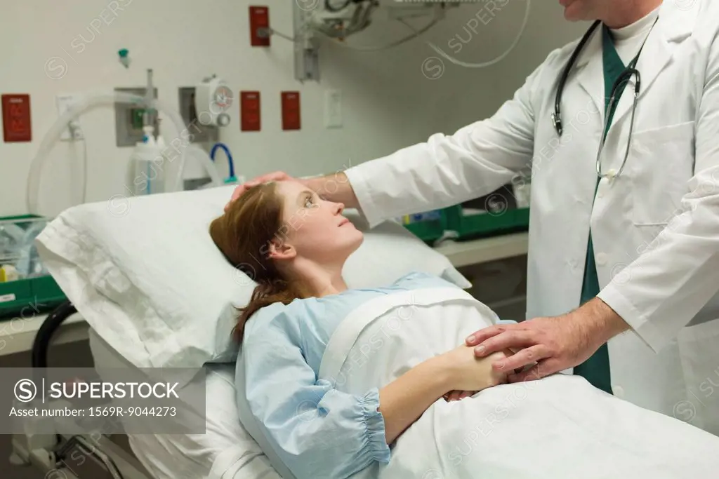 Doctor comforting patient in hospital
