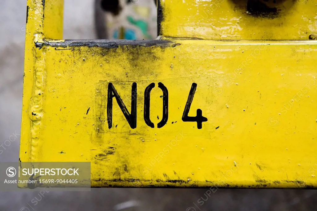 No 4 stenciled on yellow metal surface in factory