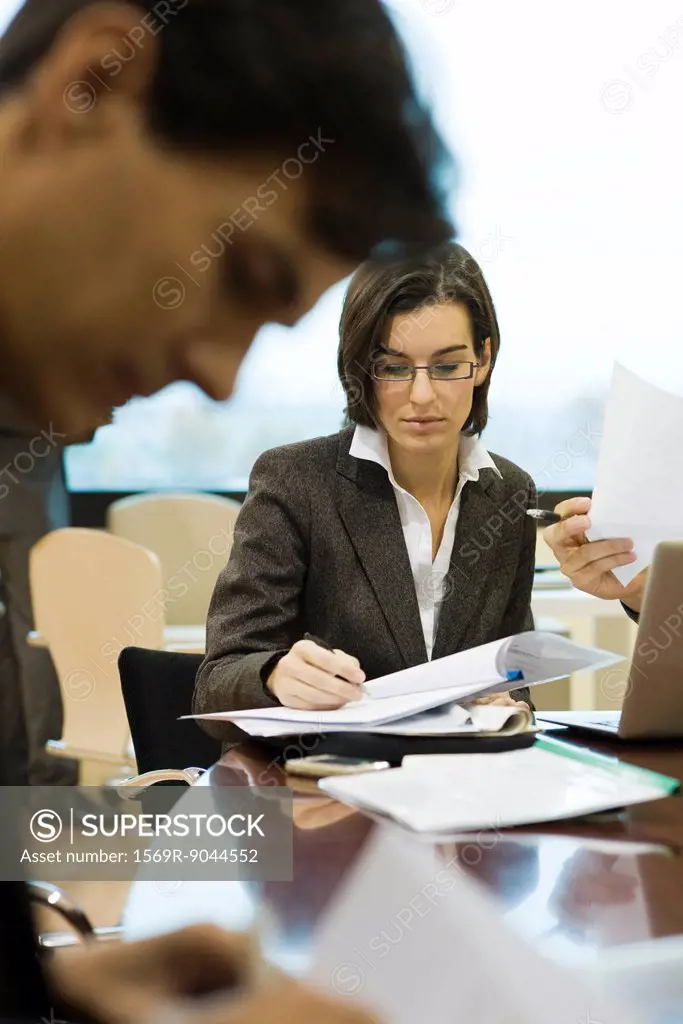 Executives reviewing documents in meeting