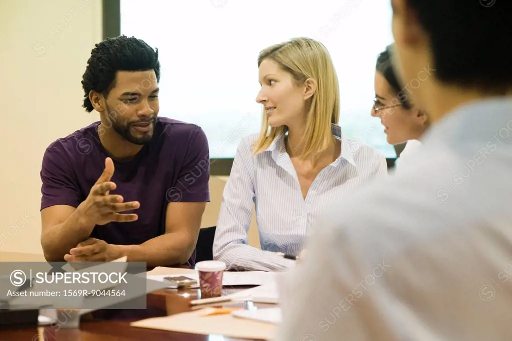 Executives listening to colleague in meeting