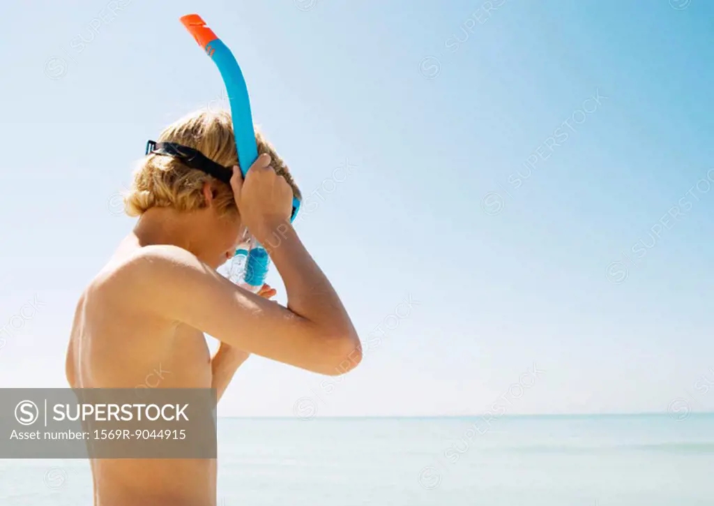 Boy adjusting snorkel