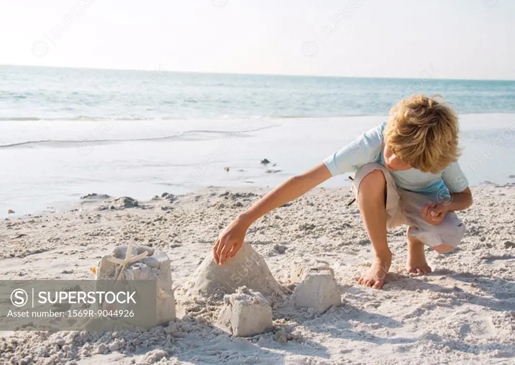 Boy building sand castle