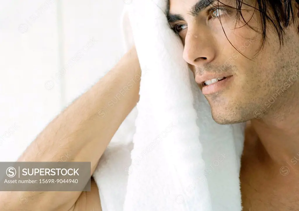 Man drying off face with towel