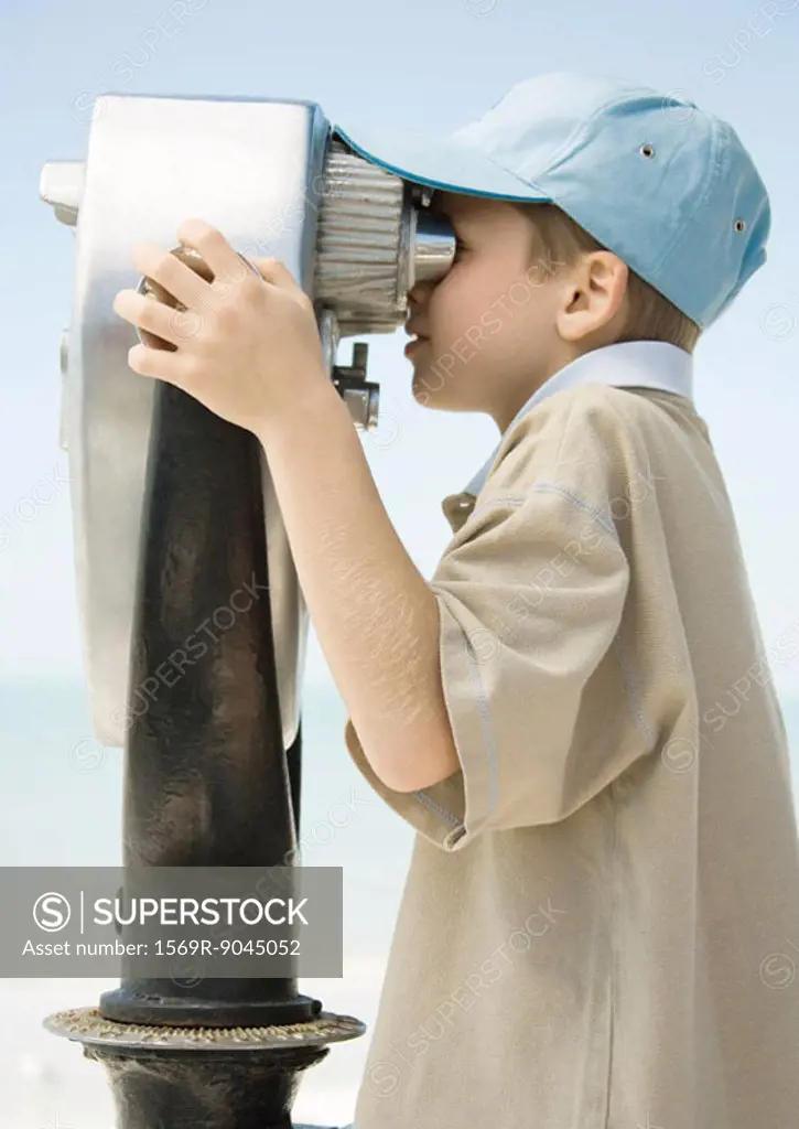 Boy looking through pay binoculars