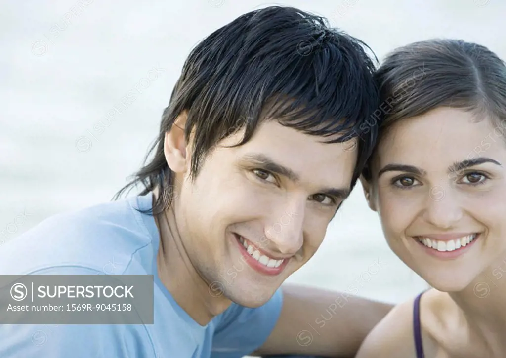 Young couple, head to head, smiling, portrait