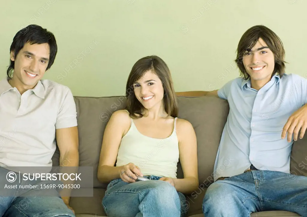 Group of young adult friends sitting on sofa