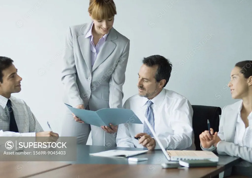 Businesswoman showing file in meeting
