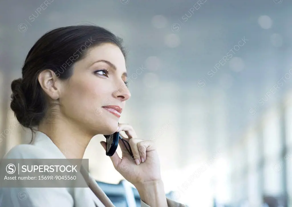 Businesswoman using cell phone, low angle view
