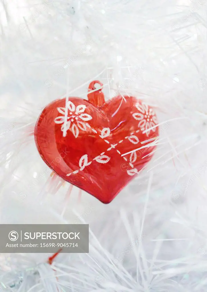 Heart ornament on white christmas tree