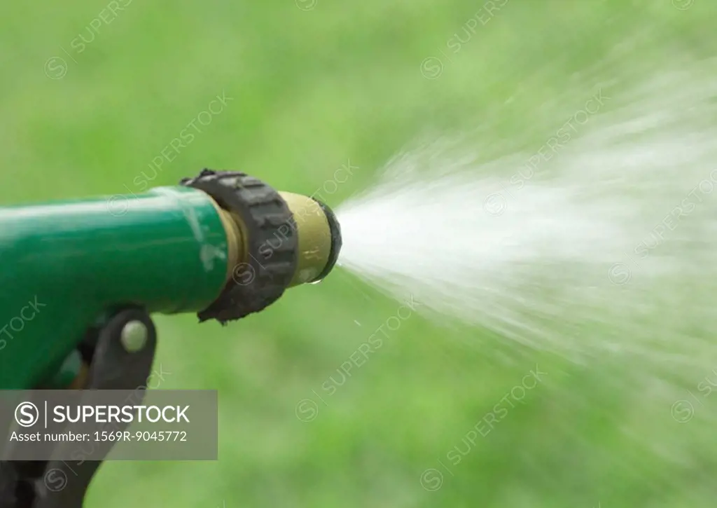 Water spraying from garden hose