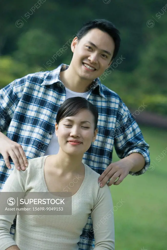 Couple, man massaging woman´s shoulders, woman closing eyes