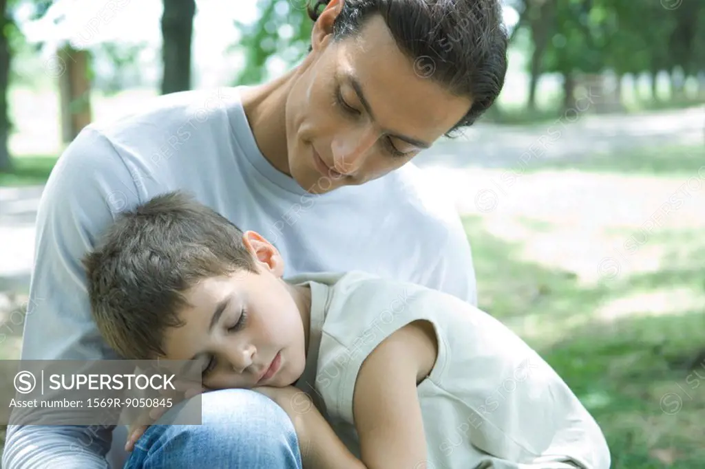 Boy and father, boy sleeping in man´s lap