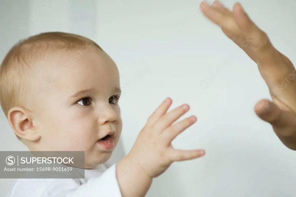 Baby reaching for mother´s hand