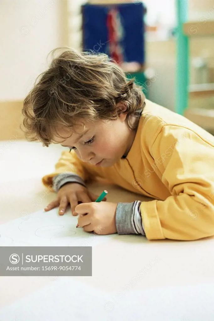 Little girl drawing at desk