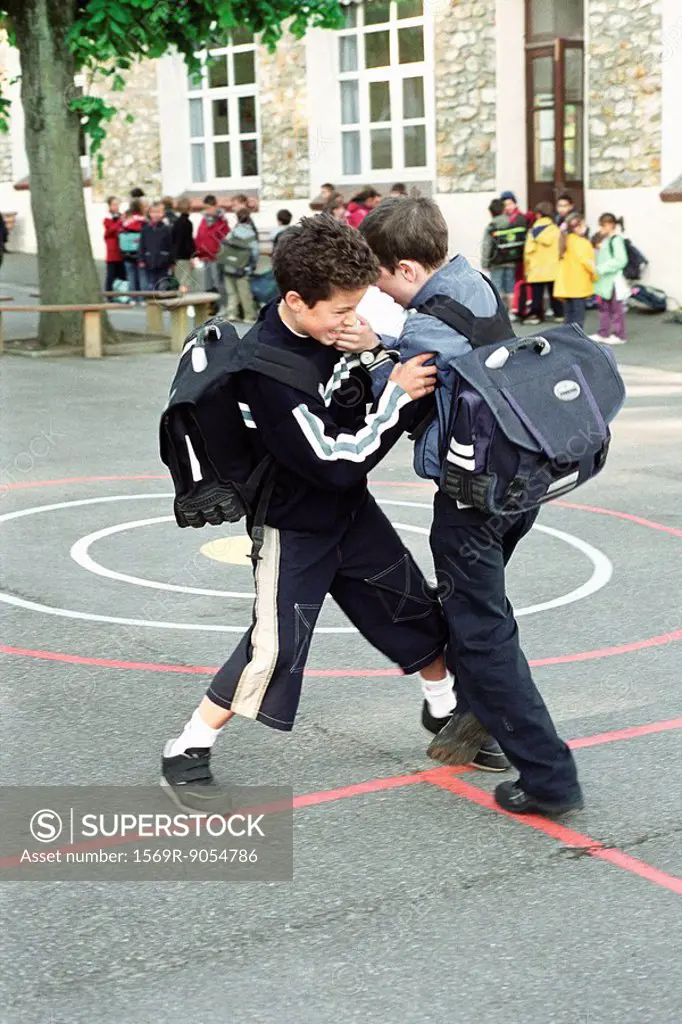 Boys fighting on school playground