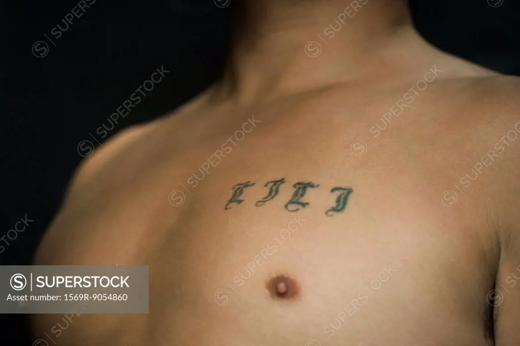 Tattooed letters on man´s chest