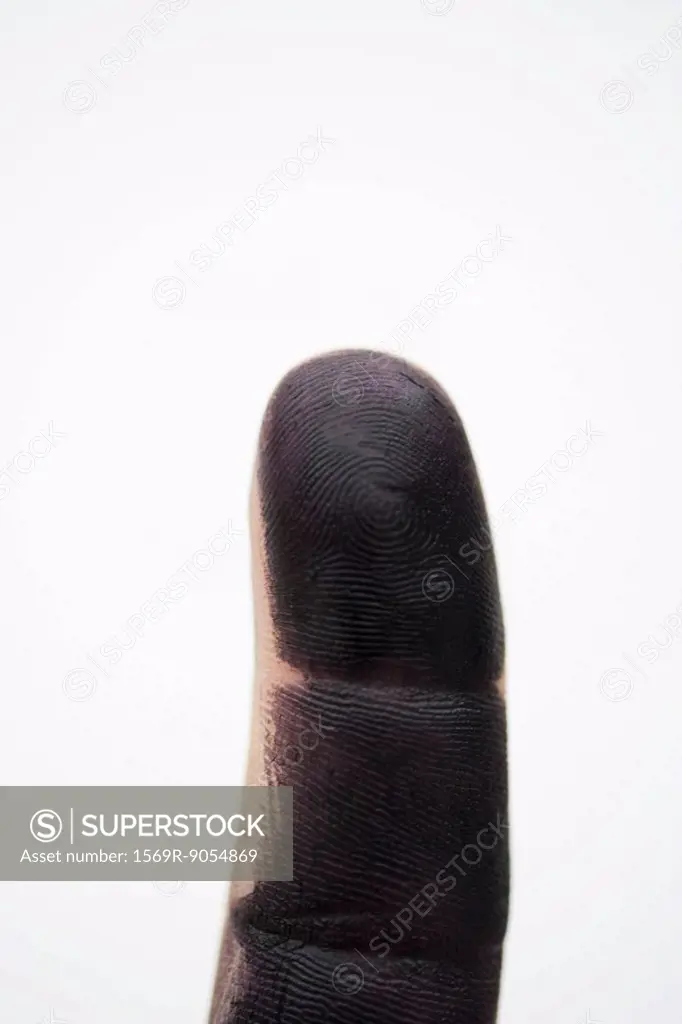 Finger covered with black paint